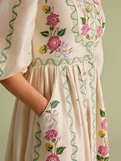 A close-up of the pocket and side embroidery, showing the thoughtful details that make this dress special.