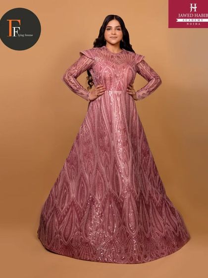 A model in an intricately detailed pink gown, with hair and makeup by our students for a professional shoot.