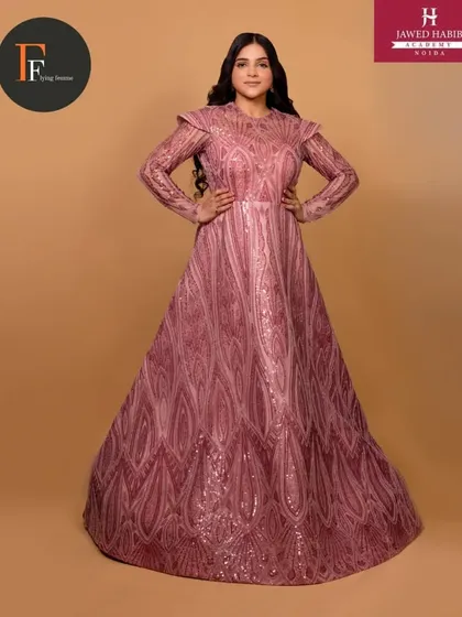 A model in a detailed pink gown, showcasing an elegant and regal look created by our students.