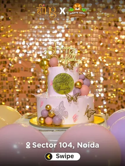 A beautiful two-tier cake with butterfly and gold accents, set against a sparkling gold sequin backdrop. A perfect centerpiece for a magical party.