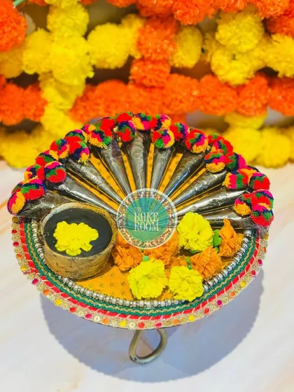 An edible Chocolate Mehandi Cone Platter, perfect for Karva Chauth or wedding celebrations. The cones, flowers, and bowl are all made from chocolate, offering a unique and delicious festive treat.
