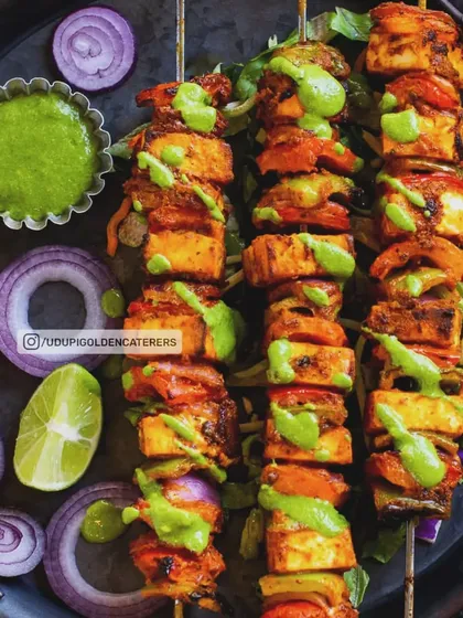 Vibrant Paneer Tikka skewers, grilled to perfection. We marinate soft paneer cubes and fresh vegetables in aromatic spices, then grill them live at your event, delivering a smoky, delicious appetizer that is always a crowd favorite.