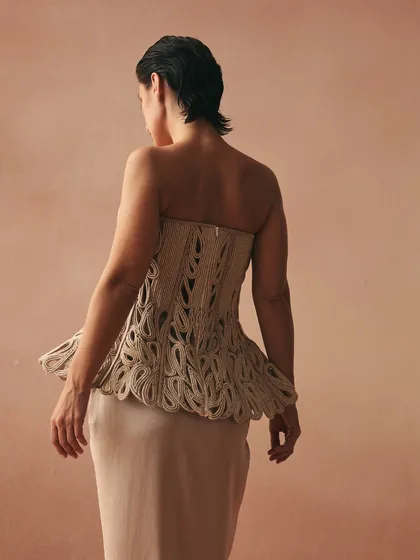 The back of the Karov corset, showcasing the meticulous handcrafting of paisley motifs in zari threads on a cotton base. It is a testament to the memory of touch.