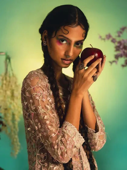 From the 'Garden of Eden' editorial, this look features creative, dual-toned eyeshadow and long, classic braids. This showcases my ability to blend traditional styles with modern, artistic makeup.