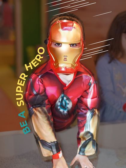 A young hero channels Iron Man. Our dress-up corner allows kids to become their favorite characters, fostering imaginative play and making them feel powerful.