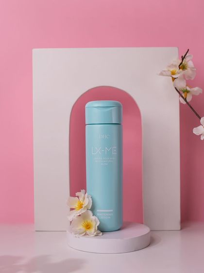 A clean and elegant shot for DHC Beauty. The product is placed on a podium in front of a white arch prop, with delicate flowers adding a touch of softness and sophistication.