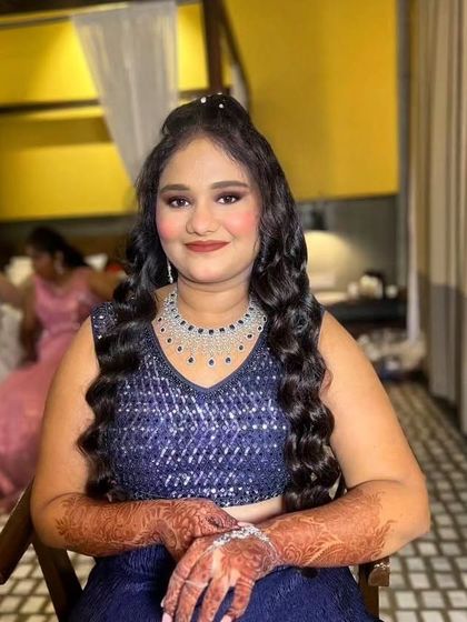 A beautiful reception look for this client in a deep blue lehenga. The makeup is kept glamorous with a defined eye and glowing skin, perfect for an evening celebration.