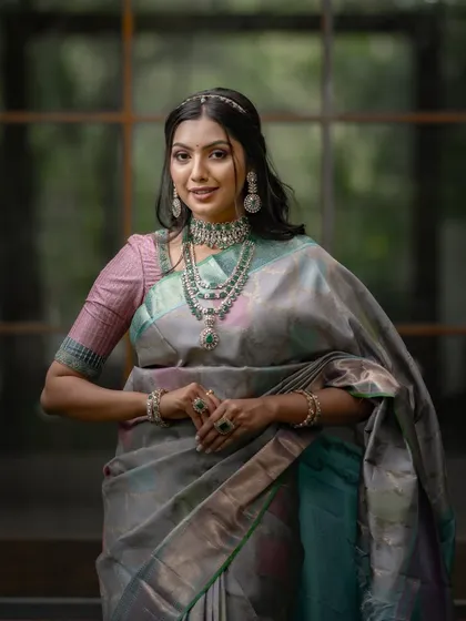 This is for the bride who seeks tradition with a touch of modern glamour. This unique Kancheevaram silk, with its blend of grey, pink, sky blue, and lavender, is a piece of wearable art designed to dazzle at any grand occasion.