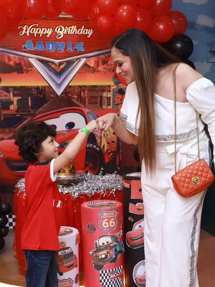A sweet moment between mother and son at his Cars-themed birthday party. I focus on creating a happy atmosphere where families can make lasting memories.