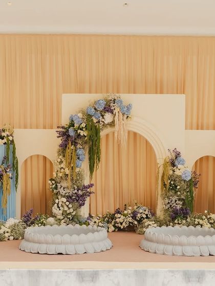 The main stage for the 'Petals of Joy' Haldi, featuring modern arches, floral installations, and elegant seating for the couple.