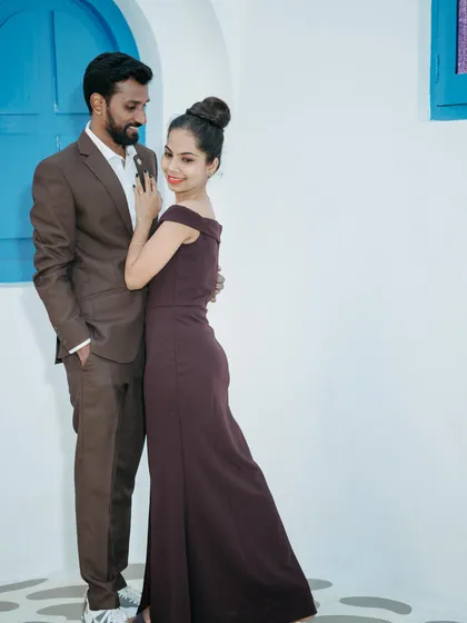 A stylish couple's portrait against a clean, modern backdrop. This highlights our versatility in creating both traditional and contemporary pre-wedding photos.