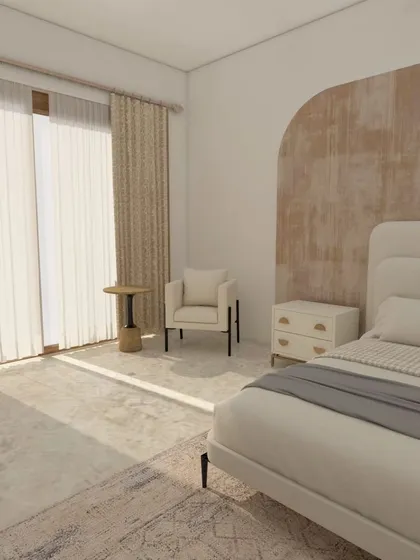 This angle shows the reading corner by the window, a perfect spot to relax with a book. The natural light and soft furnishings make this master bedroom feel like a true sanctuary.