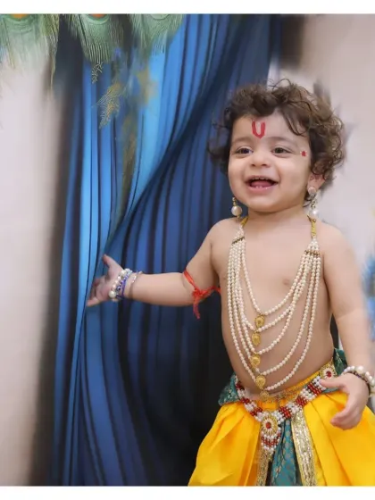 A happy, candid moment during a Krishna-themed session. We encourage play and movement to capture genuine smiles and the joyful spirit of your child.