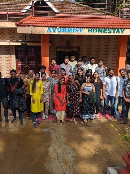 The group posing outside the Ayurmist Homestay during the Netravathi trek.