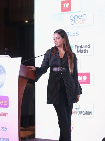 Moving from behind the podium to engage with the stage, ensuring a dynamic presence even during formal events.