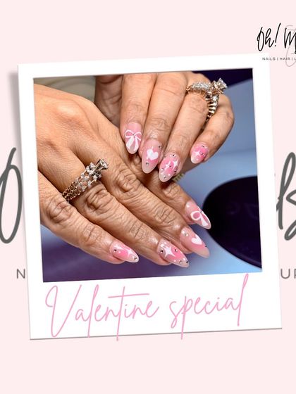 Your nails deserve all the Valentine's love too. This sweet set features a sheer pink base with hand-painted hearts, bows, and "XO" details.