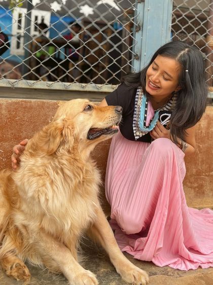 A sweet interaction as a visitor gazes lovingly at a Golden Retriever.