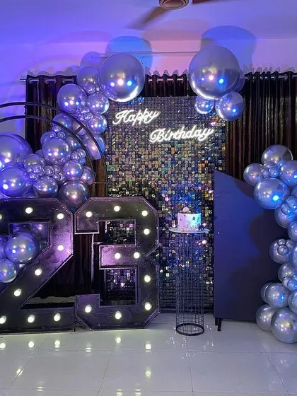 Another angle of the sleek silver and black party, showing the personalized name sign and the overall cool, modern aesthetic.