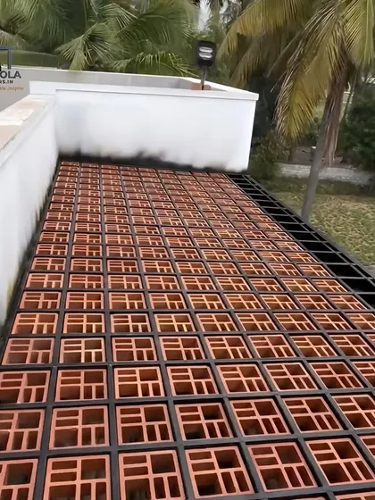 A rooftop structure made from jali bricks set within a metal grid. This design provides a semi-covered space that allows for ventilation and creates interesting shadow patterns, perfect for a hot climate.