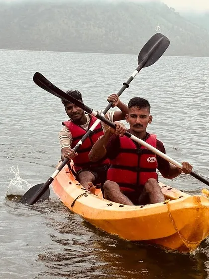 Two participants in a tandem kayak work together to power through the water, a great exercise in coordination.