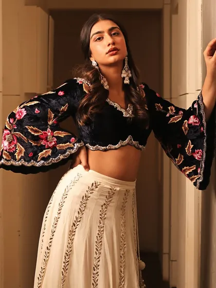 A full view of the contemporary ethnic ensemble. The makeup is designed to be elegant and photogenic, balancing the detailed blouse with a fresh, polished beauty look.
