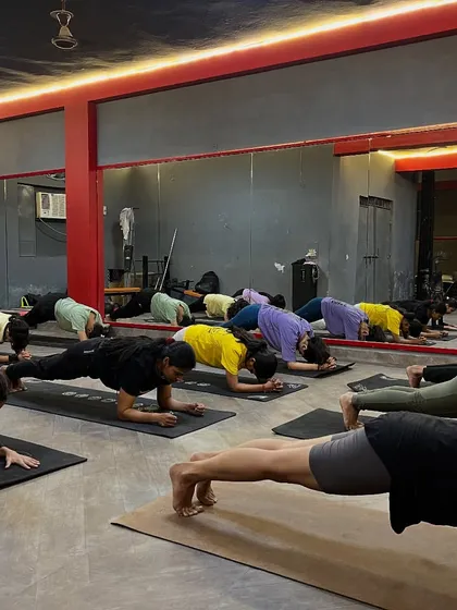 Building core strength with a group plank pose. A strong core is essential for good posture and preventing back pain from sitting.
