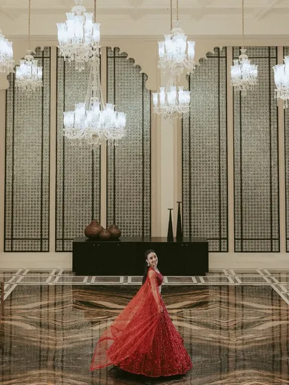 A portrait of regal elegance. We see every bride as royalty, and we take the time to compose shots that highlight her grace and the stunning details of her attire within the grandeur of the wedding venue.