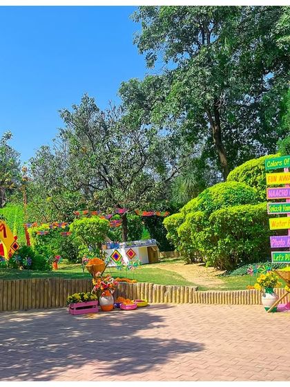 The entrance path to the Holi party was lined with colorful directional signs and marigold flower arrangements, guiding guests into the heart of the celebration.