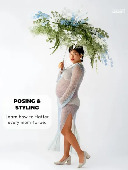A creative maternity portrait with a floral umbrella prop, demonstrating artistic and conceptual styling.