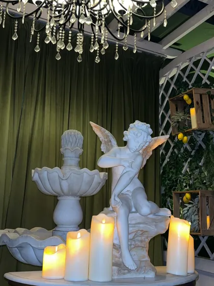 The decor at Kipo, featuring cherub statues and candles, adds to the romantic vibe.