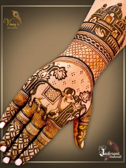 A beautiful depiction of a sacred cow and calf on the palm, surrounded by lotus flowers and an architectural dome on the wrist.
