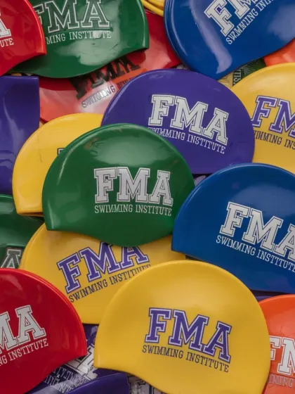 A close-up of our vibrant FMA swimming caps. Made from durable material, these caps are perfect for training and competitions.