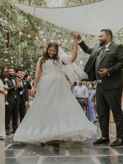 A joyful moment as a couple makes their way down the aisle after their ceremony. The happiness is contagious as they are surrounded by their cheering friends and family.