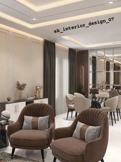 An open-plan living and dining area where we used furniture grouping to define the space. The living area features plush brown armchairs, while the dining zone is marked by a sleek table and chairs, all unified by consistent wall treatments and a neutral color palette.