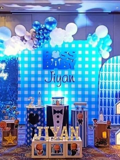 A cool Boss Baby theme for a second birthday. The setup uses blue lighting, a shimmer wall, and multiple character cutouts to create a fun party scene.