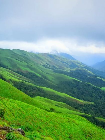 The rolling green hills of the Kudremukh range, a view you can enjoy on our treks to Didupe and Ermayi falls.