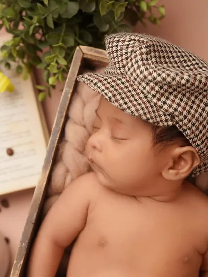 A close-up portrait of the sleeping baby in his newsboy cap. Even in a themed shoot, I always make sure to capture these peaceful, detailed shots of your little one.
