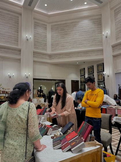 A vendor explains her natural products to an interested customer. This one-on-one interaction is what makes pop-up events so valuable for brands.