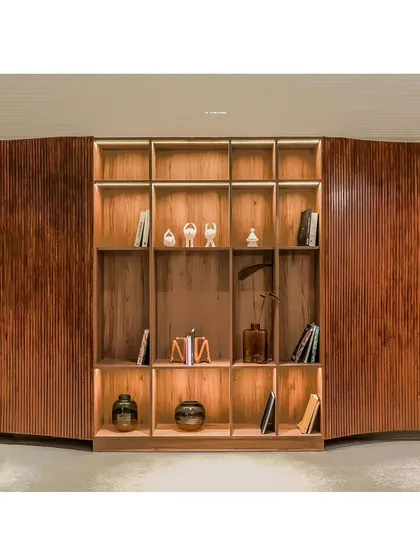 Here, a portion of the fluid wall opens up to reveal an integrated bookshelf, turning a simple corridor into a mini library and reading area for residents.