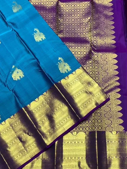 A close-up of the border and elephant motifs on the blue Kanchipuram silk saree.