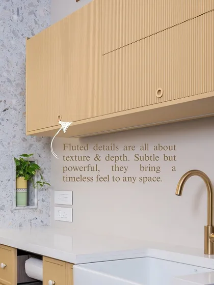 Fluted details bring a subtle but powerful sense of texture and depth to a space. Here, on these pale yellow upper cabinets, the vertical lines create a timeless feel that is both sophisticated and warm.