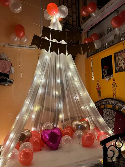 A close-up shot of the intimate canopy tent, filled with heart-shaped and regular balloons, ready for a romantic celebration.