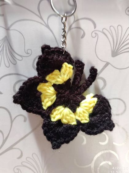 Elegant black butterfly keychains with pops of color like orange, blue, pink, purple, and yellow on the wings.