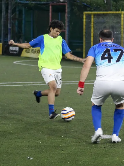 A young professional dribbles past a defender, demonstrating the agility and ball control we help our players develop through structured drills and match practice.