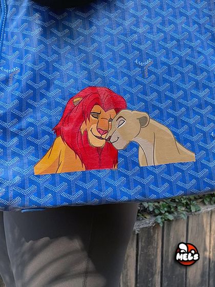A detailed shot of the Simba and Nala painting, showing the emotion and connection between the two characters.