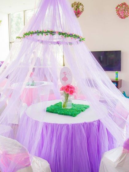 A beautiful fairy-themed seating area under a tulle canopy. This created an intimate and magical space for the little fairies to gather during the party.