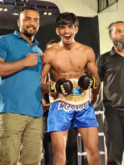 This is what we train for. One of my fighters holding the AIMMAF title belt after a hard-earned victory in Siliguri. I don't just train you; I am in your corner on fight night, guiding you to the win.