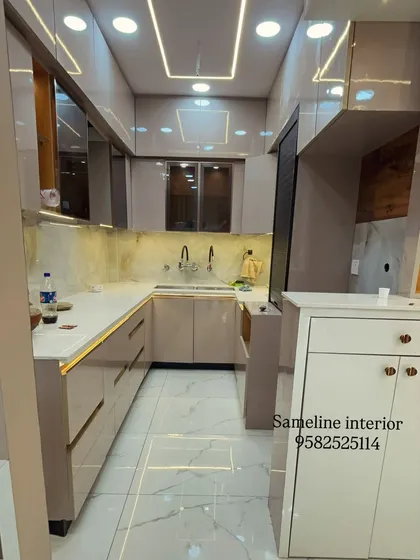 The completed U-shaped kitchen with its false ceiling design featuring both recessed and profile lighting, ensuring the entire workspace is well lit.
