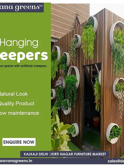 Elevate your space with artificial hanging creepers. This unique wall installation uses circular planters on a wooden wall to create a modern and artistic display of greenery.