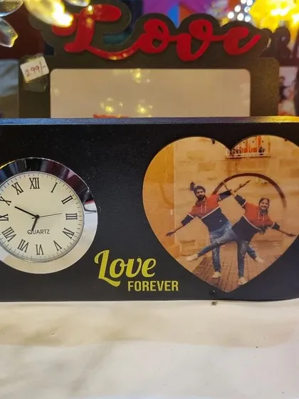 This tabletop display combines a functional clock with a heart-shaped photo frame, making it a practical and sentimental gift for a loved one.